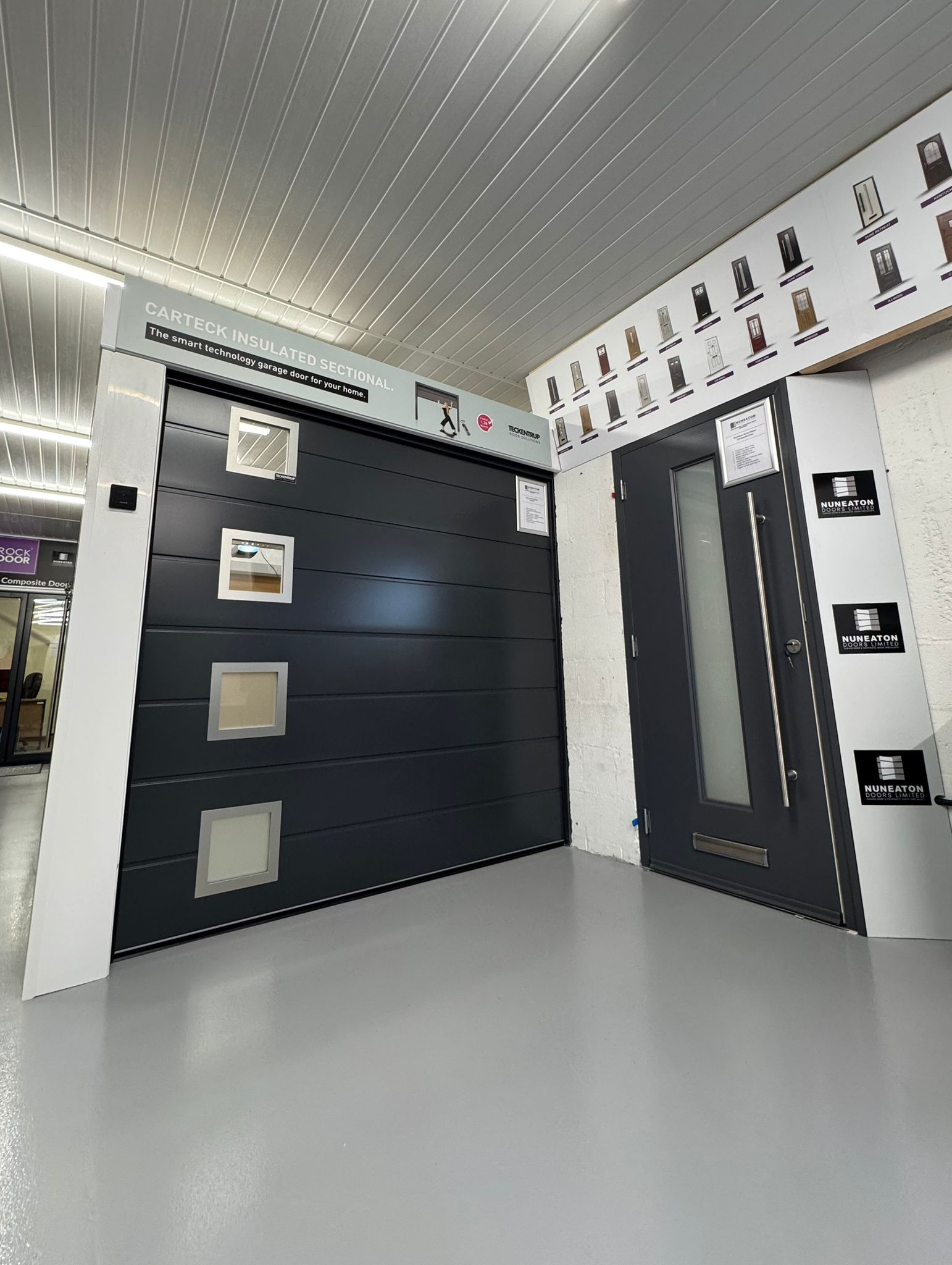 Black garage doors with window panels to left